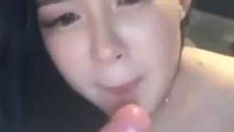 A Korean girl had a blowjob outdoors in the car at night, with a vibrator stuffed into her pussy and then a condom, moaning and gasping