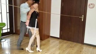 Bondage y entrenamiento de una joven y guapa modelo vestida de sirvienta con medias