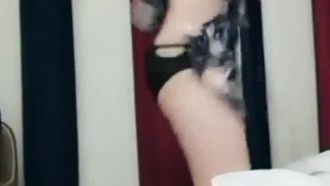 The sweet-looking and slender little beauty slowly takes off her clothes on the bed and licks her pussy with her fingers