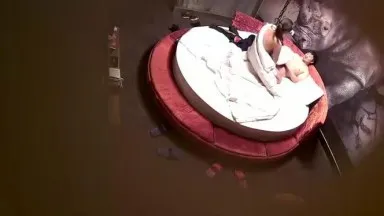 A middle-aged business man and a young woman were secretly filmed on a big round bed in a boutique hotel and smoked cigarettes after having an affair.