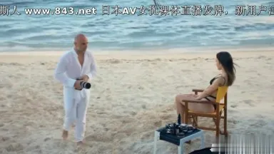 Good-looking foreign girl and bald man having sex on the beach