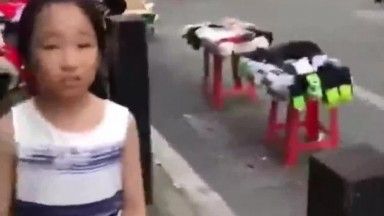 A strong and bold mother shows off her child in the street